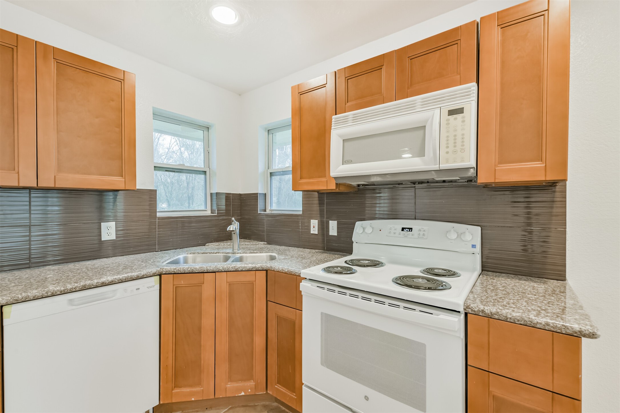 10412 Ehlers Road Conroe, TX 77302 - Photo 10 of 37 a kitchen with granite countertop a sink stove and cabinets