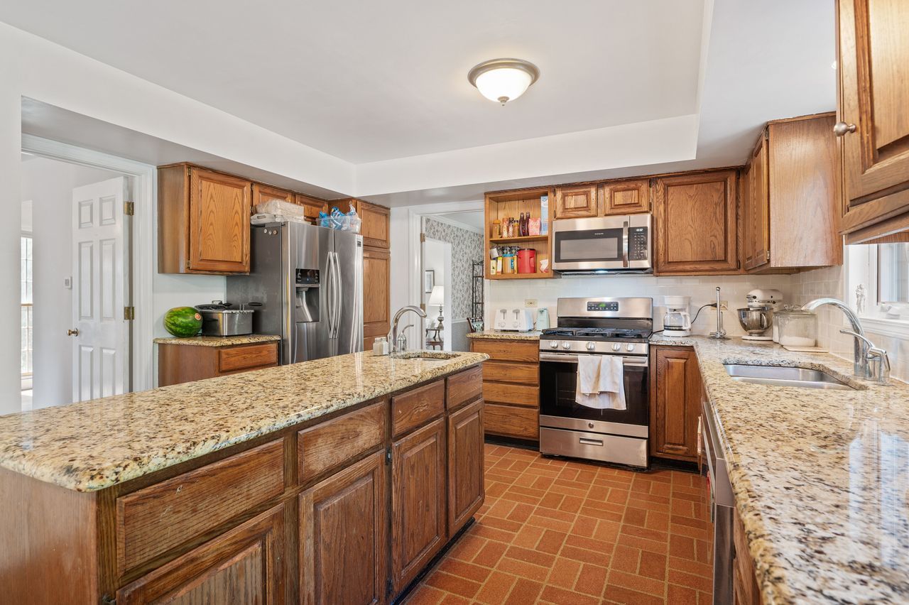 6 Crawling Stone Road Barrington Hills, IL 60010 - Photo 13 of 33 a kitchen with stainless steel appliances granite countertop a stove a sink and a refrigerator