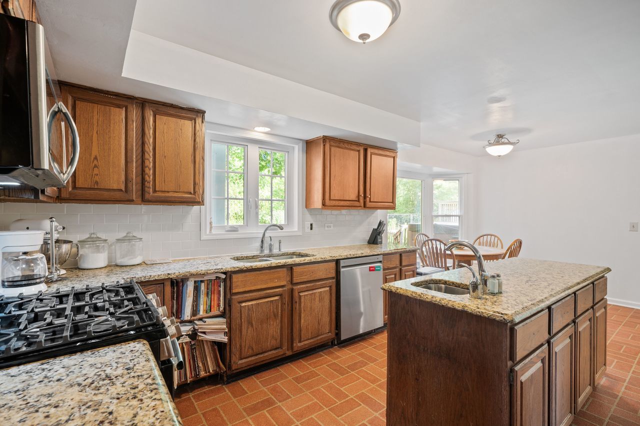 6 Crawling Stone Road Barrington Hills, IL 60010 - Photo 15 of 33 a kitchen with a sink stove and cabinets