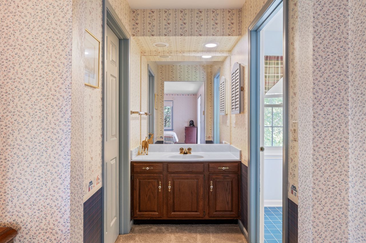 6 Crawling Stone Road Barrington Hills, IL 60010 - Photo 22 of 33 a bathroom with a granite countertop sink a mirror and a vanity