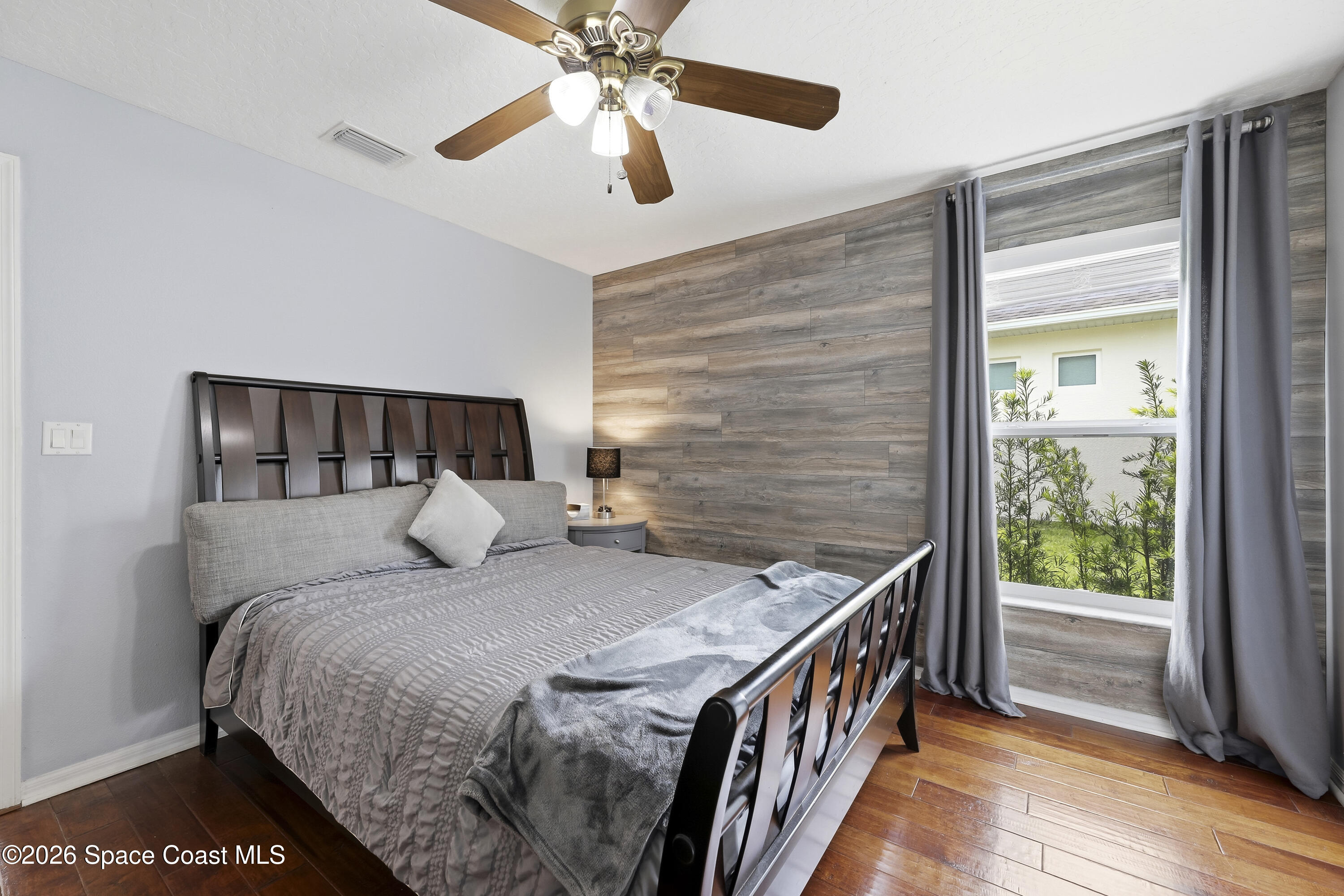 1643 Long Pine Road Melbourne, FL 32940 - Photo 39 of 63 a bedroom with a bed and a large window