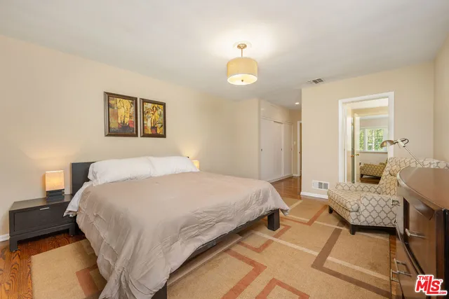 a spacious bedroom with a bed and a couch