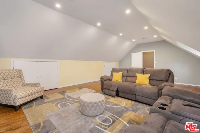 a living room with furniture and a mirror