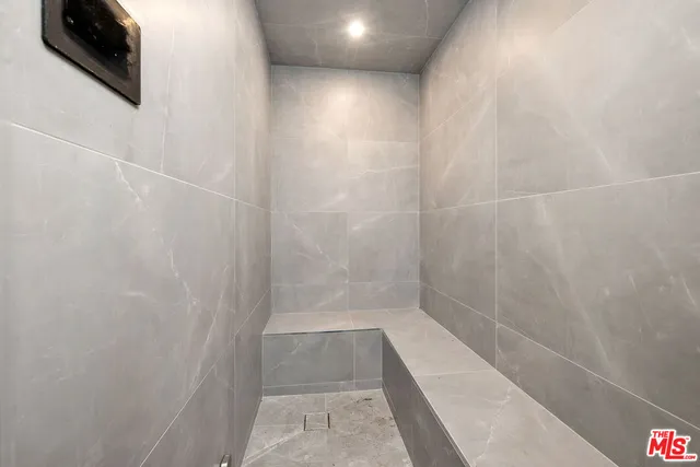 a bathroom with a shower and a mirror