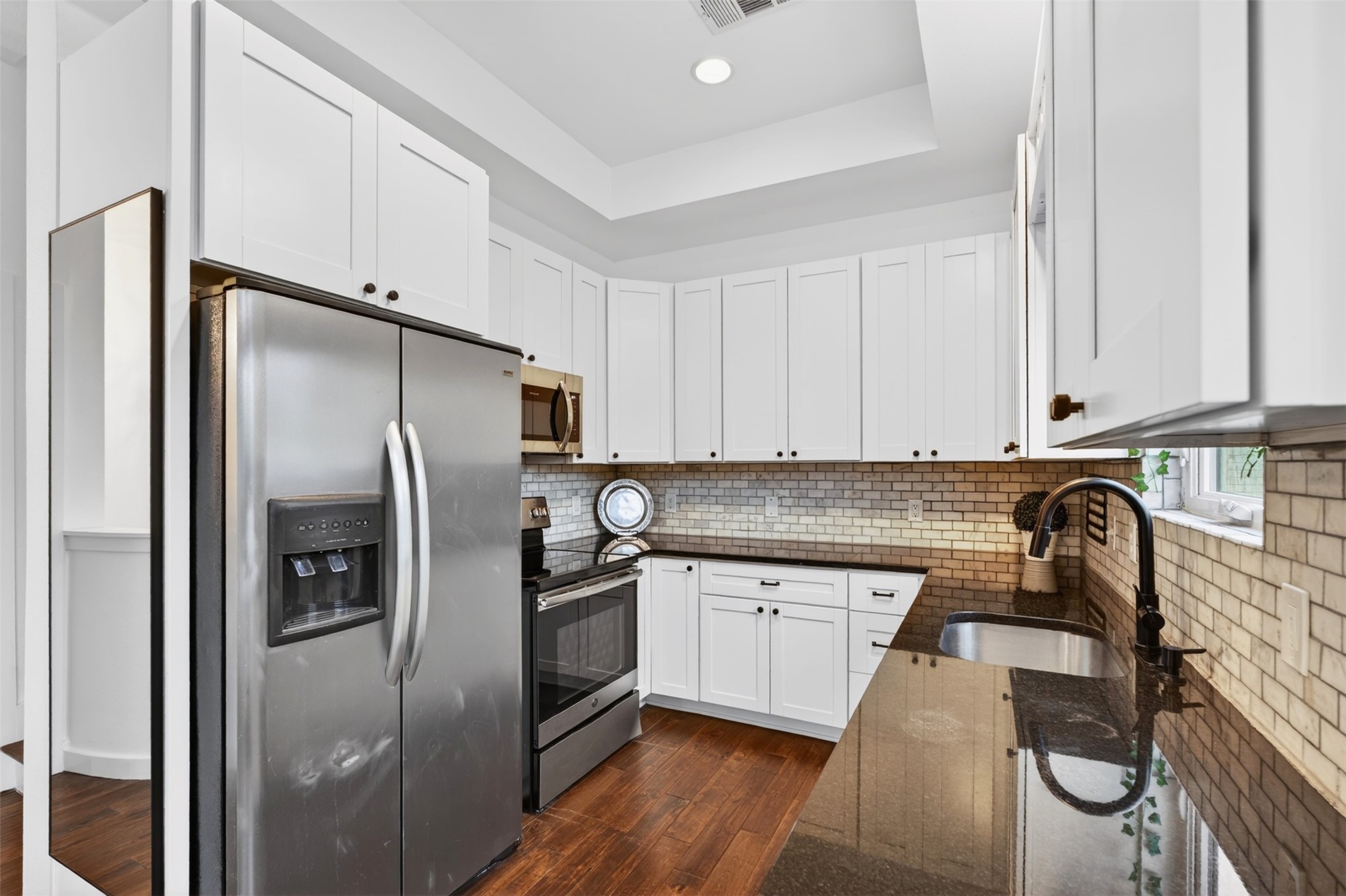 2716 Bagby Street Houston, TX 77006 - Photo 10 of 29 a kitchen with a refrigerator sink and cabinets