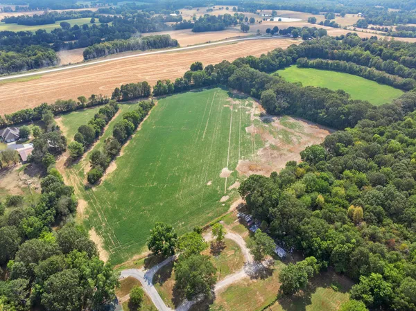 an aerial view of ocean with residential house and outdoor space