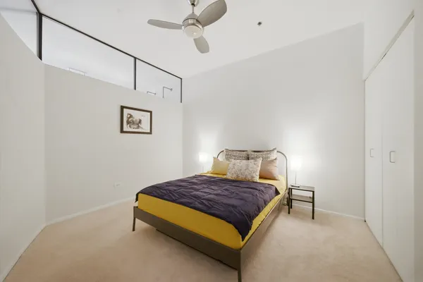 a bedroom with a bed and chair