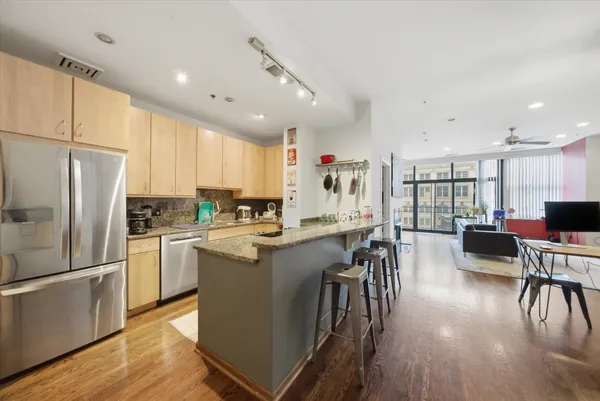 a kitchen with counter top space a sink appliances and cabinets