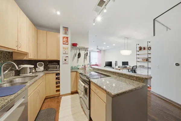 a kitchen with a sink stove and refrigerator