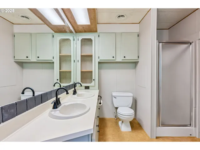 a bathroom with a sink double vanity and a mirror
