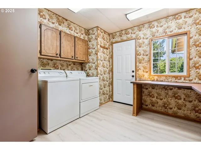 a view of walk in closet with wooden floor