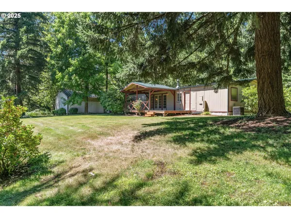 a view of house with a yard