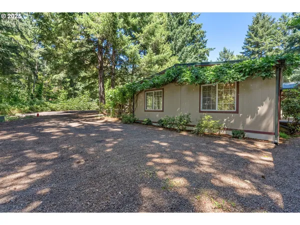 a view of a lush green hillside and houses