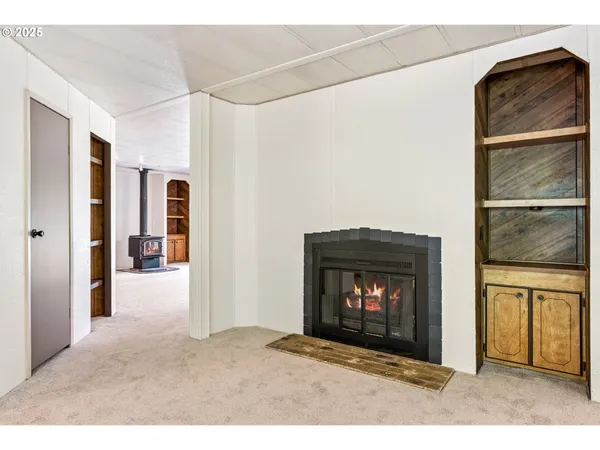 a view of an empty room with a fireplace