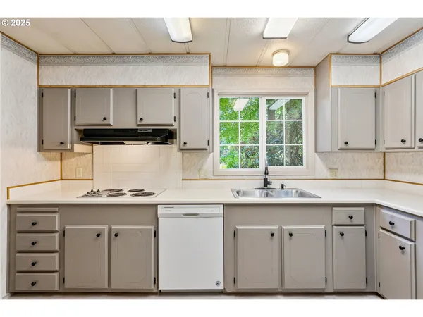 a kitchen with a sink stove and cabinets