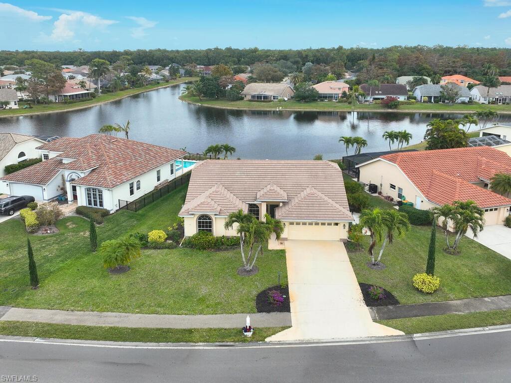 an aerial view of a house with a lake view