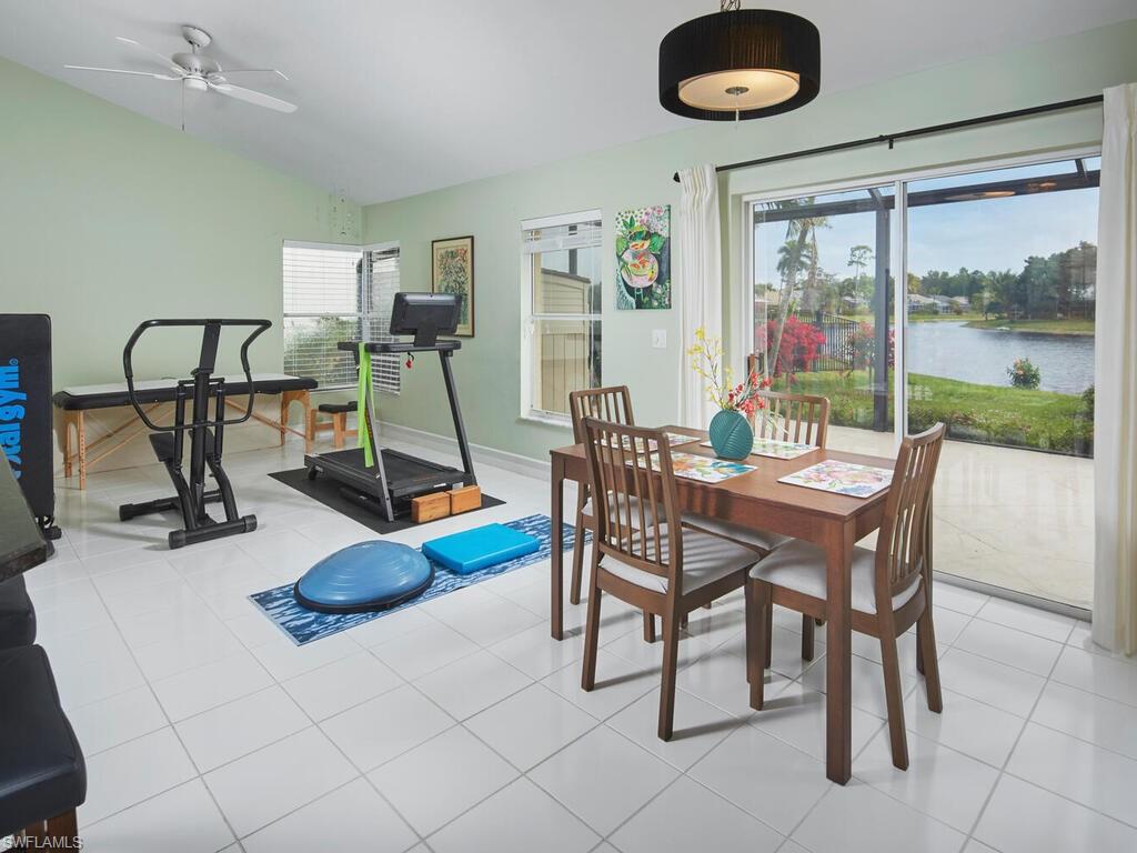 2126 East Crown Pointe Boulevard Naples, FL 34112 - Photo 11 of 26 a dining room with furniture and a floor to ceiling window