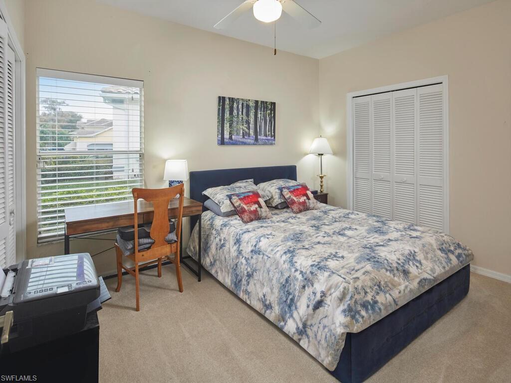 2126 East Crown Pointe Boulevard Naples, FL 34112 - Photo 16 of 26 a bedroom with bed and a window