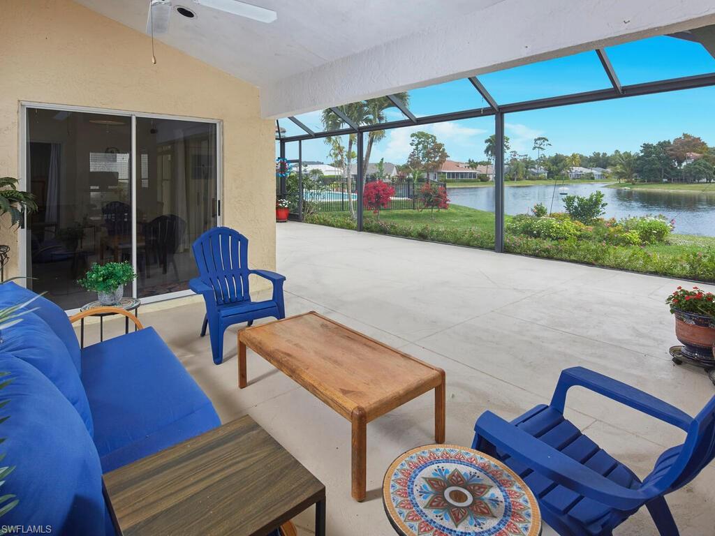 2126 East Crown Pointe Boulevard Naples, FL 34112 - Photo 18 of 26 a living room with furniture and a floor to ceiling window