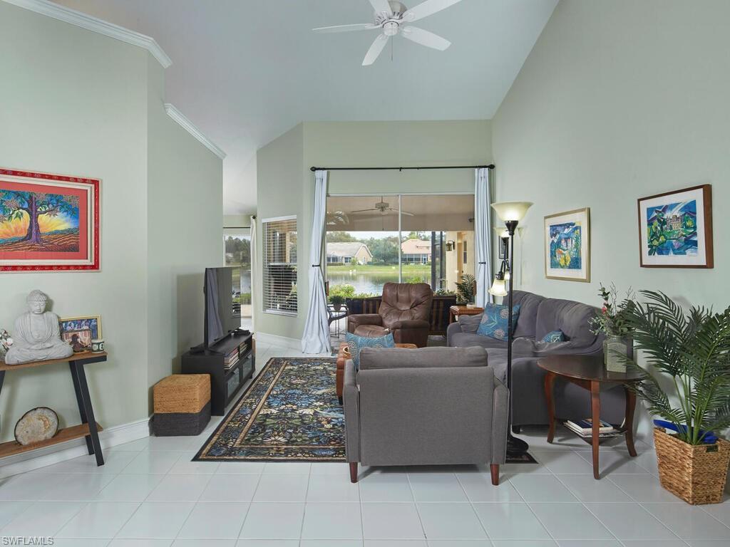2126 East Crown Pointe Boulevard Naples, FL 34112 - Photo 2 of 26 a living room with furniture and a large window