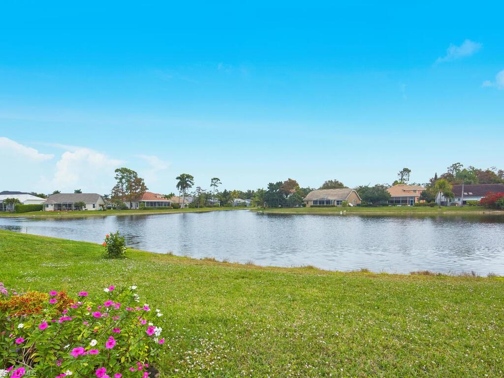 2126 East Crown Pointe Boulevard Naples, FL 34112 - Photo 21 of 26 a view of a lake with a house and lake view