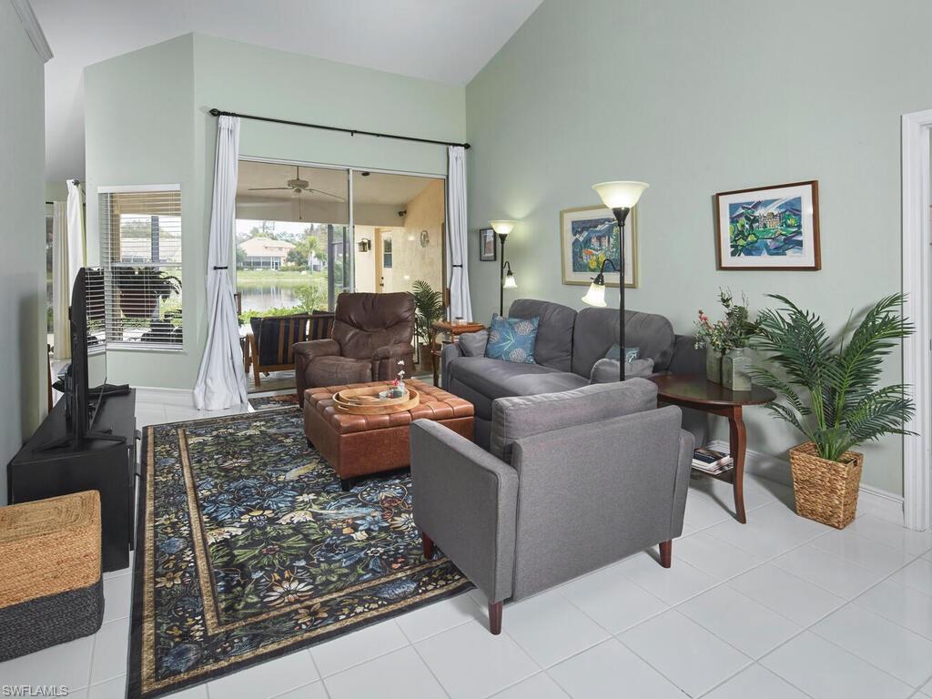 2126 East Crown Pointe Boulevard Naples, FL 34112 - Photo 3 of 26 a living room with furniture and a potted plant