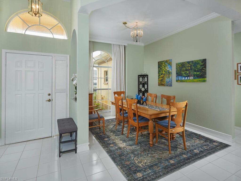 2126 East Crown Pointe Boulevard Naples, FL 34112 - Photo 4 of 26 a dining room with wooden floor and breakfast area