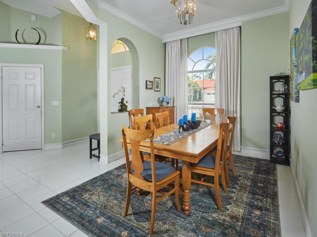 2126 East Crown Pointe Boulevard Naples, FL 34112 - Photo 5 of 26 a dining room with furniture and window