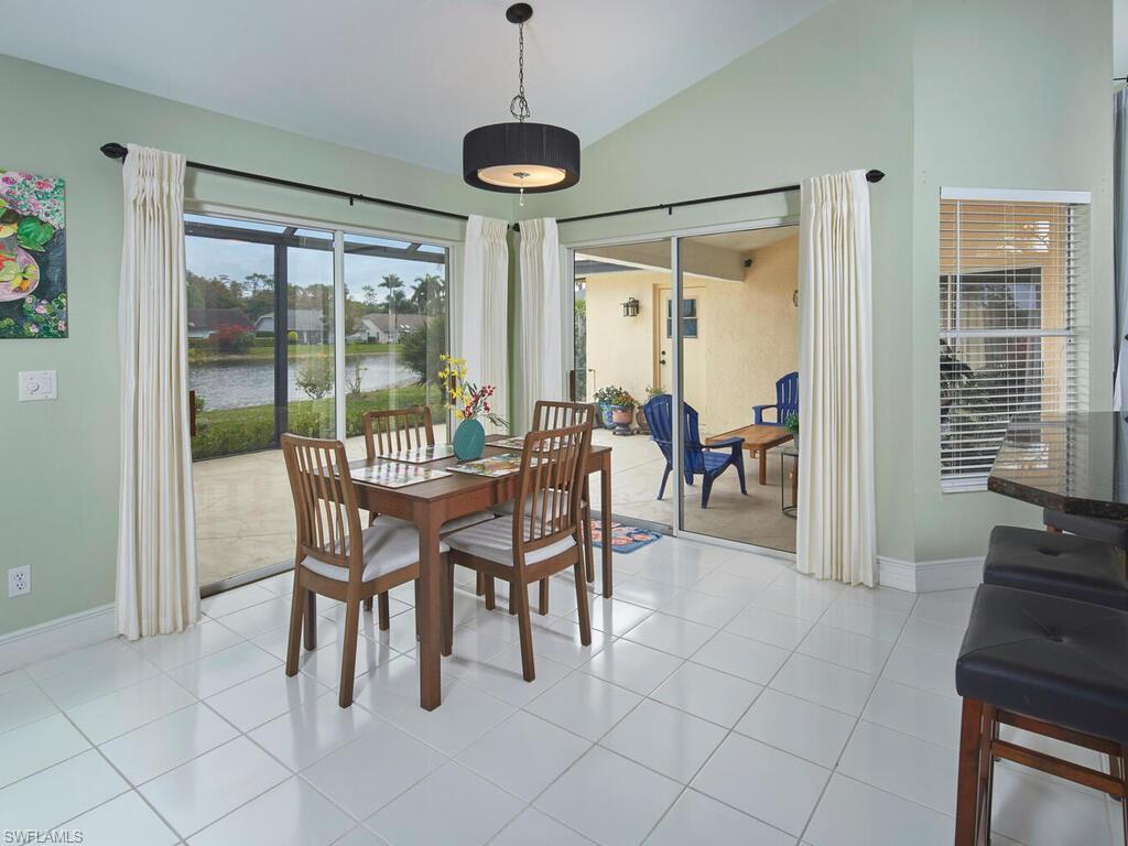2126 East Crown Pointe Boulevard Naples, FL 34112 - Photo 10 of 26 a view of a dining room with furniture window and outside view