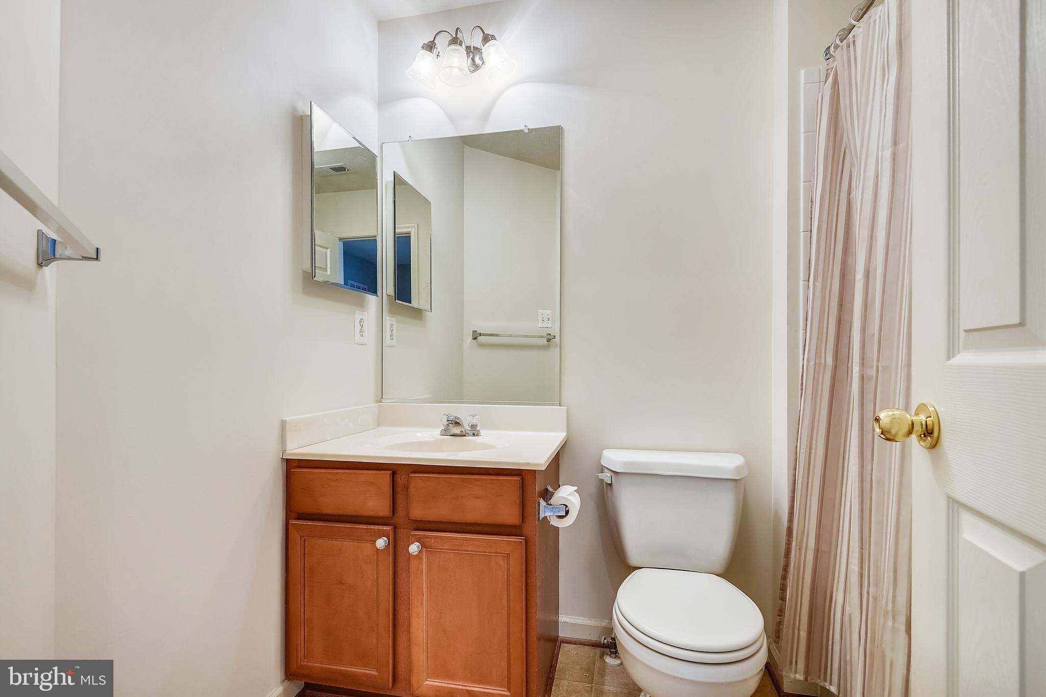 9820 Biggs Road Middle River, MD 21220 - Photo 28 of 35 a bathroom with a toilet a sink and mirror
