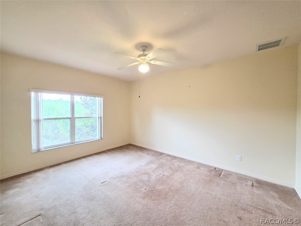 1600 West Spring Meadow Loop Lecanto, FL 34461 - Photo 17 of 28 an empty room with a window and a fan