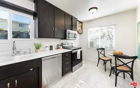 a kitchen with a sink cabinets and window