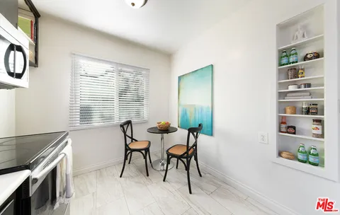 a dining room with furniture and window