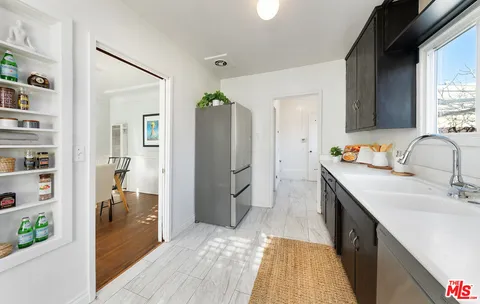 a spacious bathroom with a sink a mirror and a shower