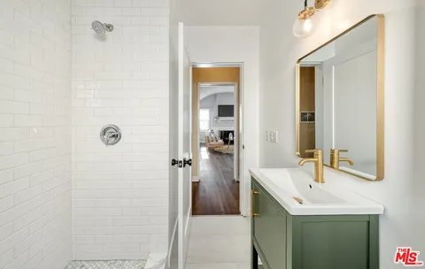a bathroom with a sink a mirror and a shower