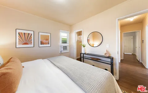 a bedroom with a bed and a dresser