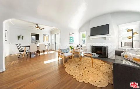 a living room with furniture fireplace and flat screen tv