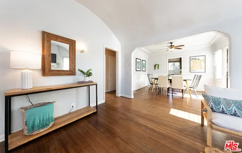 a view of living room with furniture and wooden floor