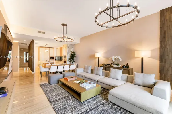 a living room with furniture a rug and white walls