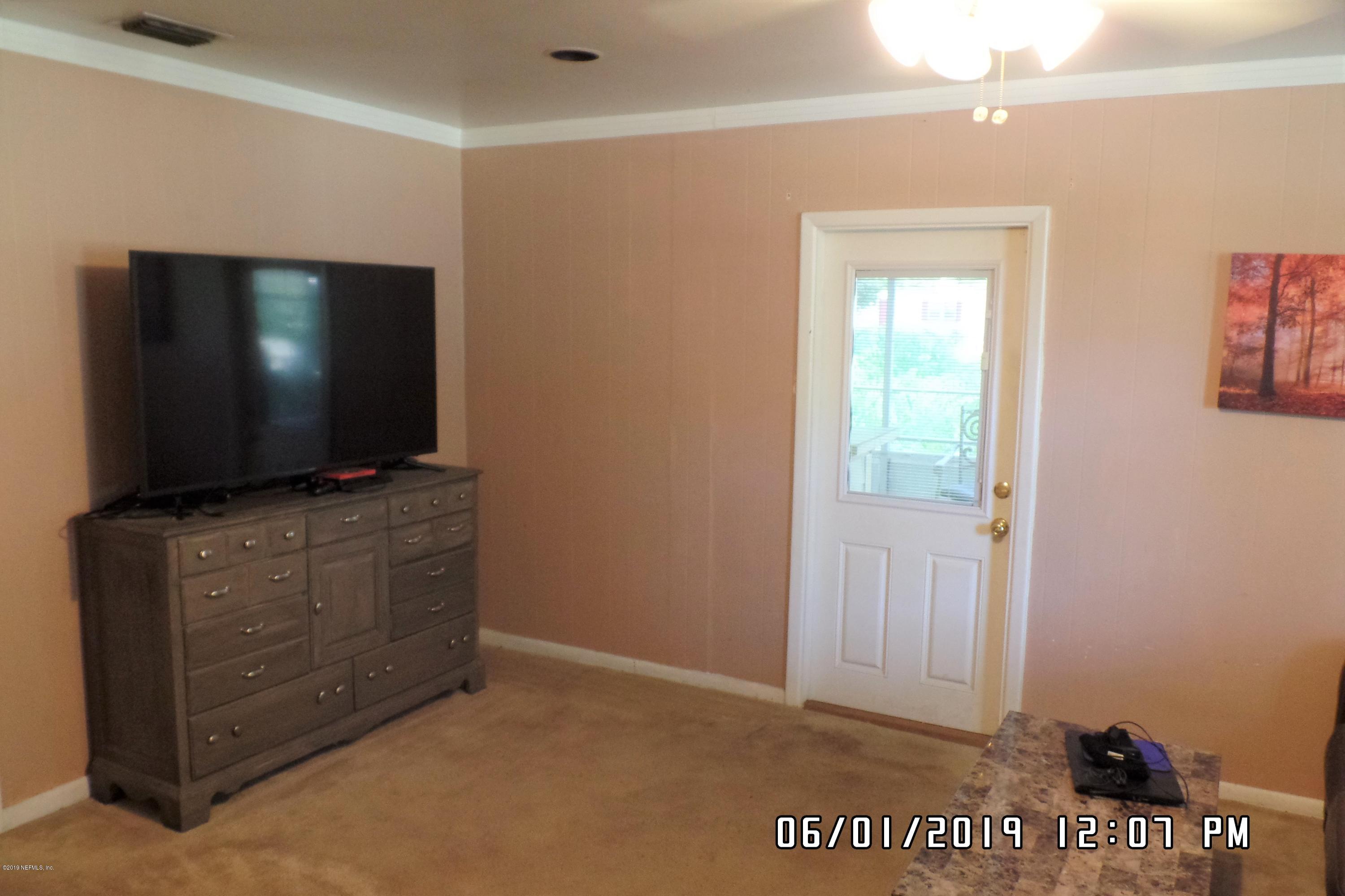 2925 Kent Road Jacksonville, FL 32216 - Photo 12 of 24 a living room with furniture and a flat screen tv