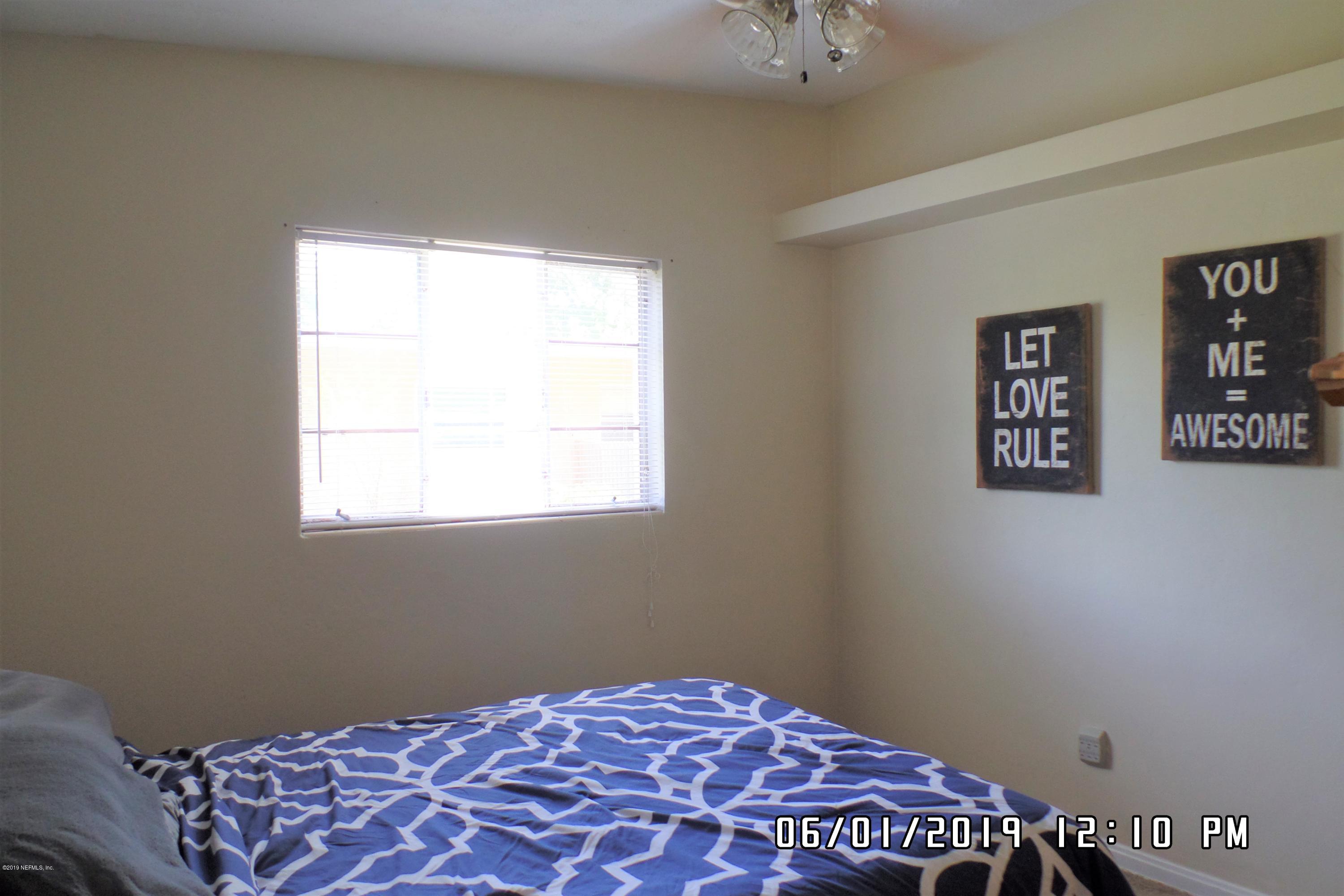2925 Kent Road Jacksonville, FL 32216 - Photo 14 of 24 a bedroom with a bed and a window
