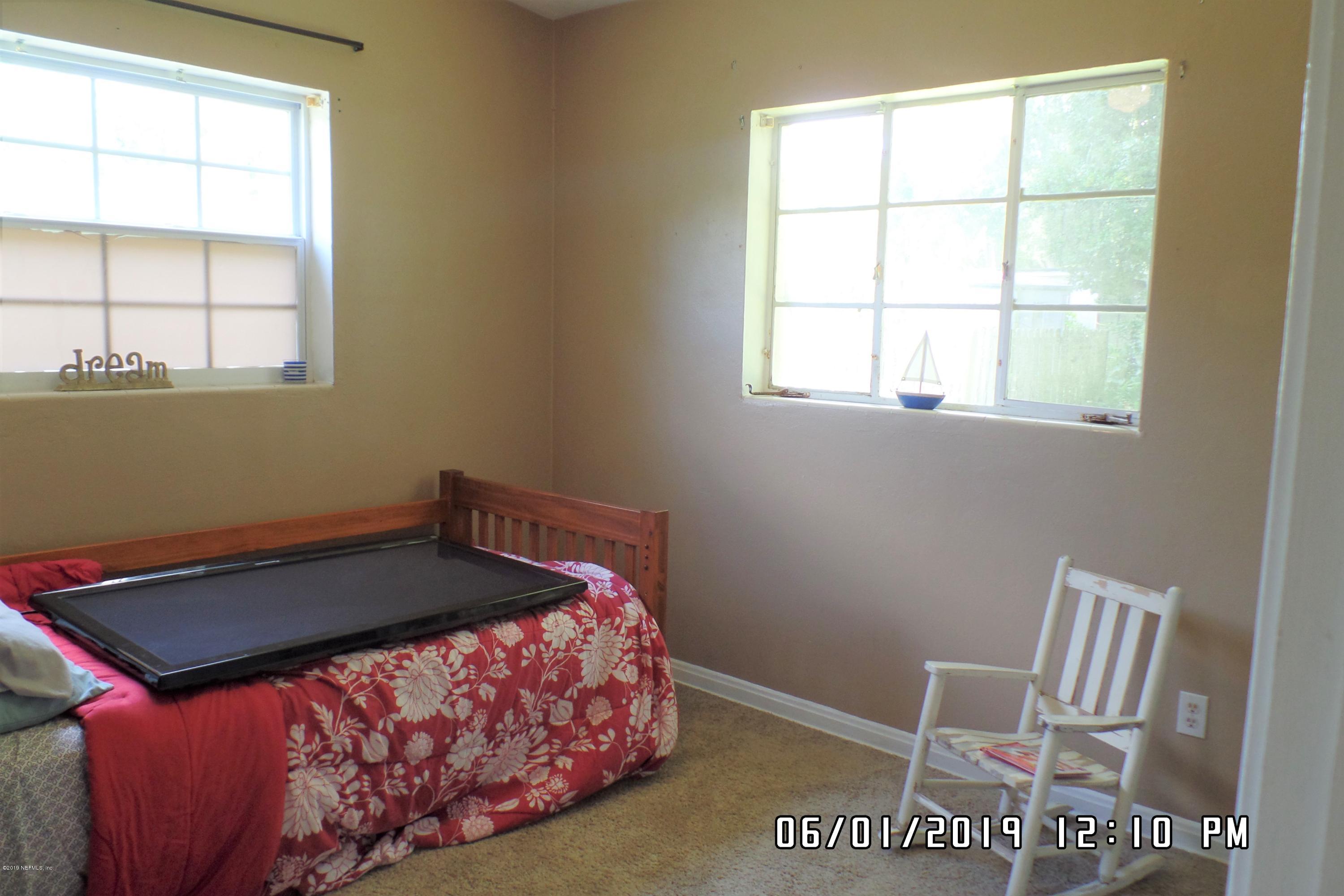 2925 Kent Road Jacksonville, FL 32216 - Photo 15 of 24 a bed sitting in a bedroom next to a window