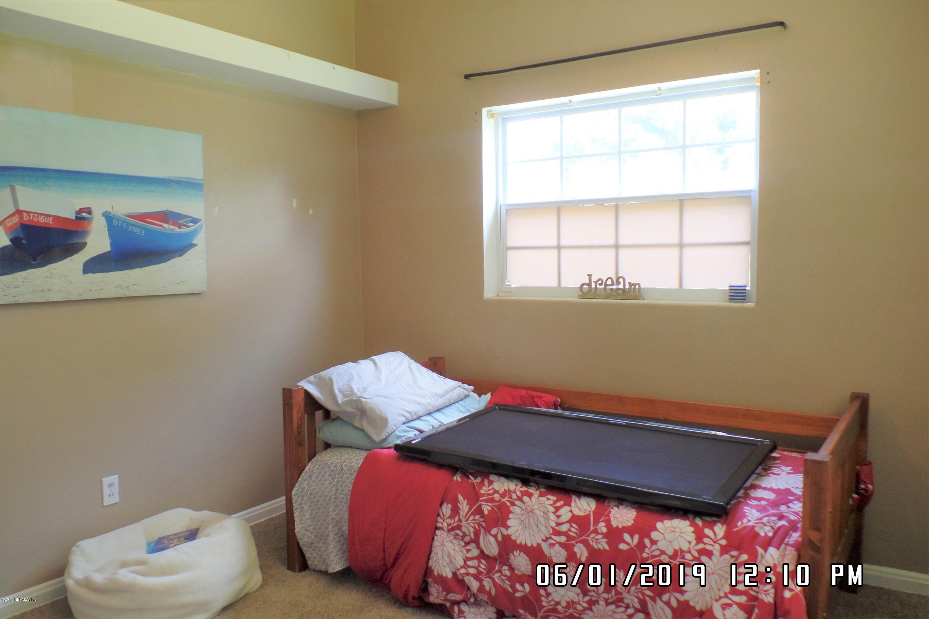 2925 Kent Road Jacksonville, FL 32216 - Photo 16 of 24 a bed sitting in a bedroom next to a window