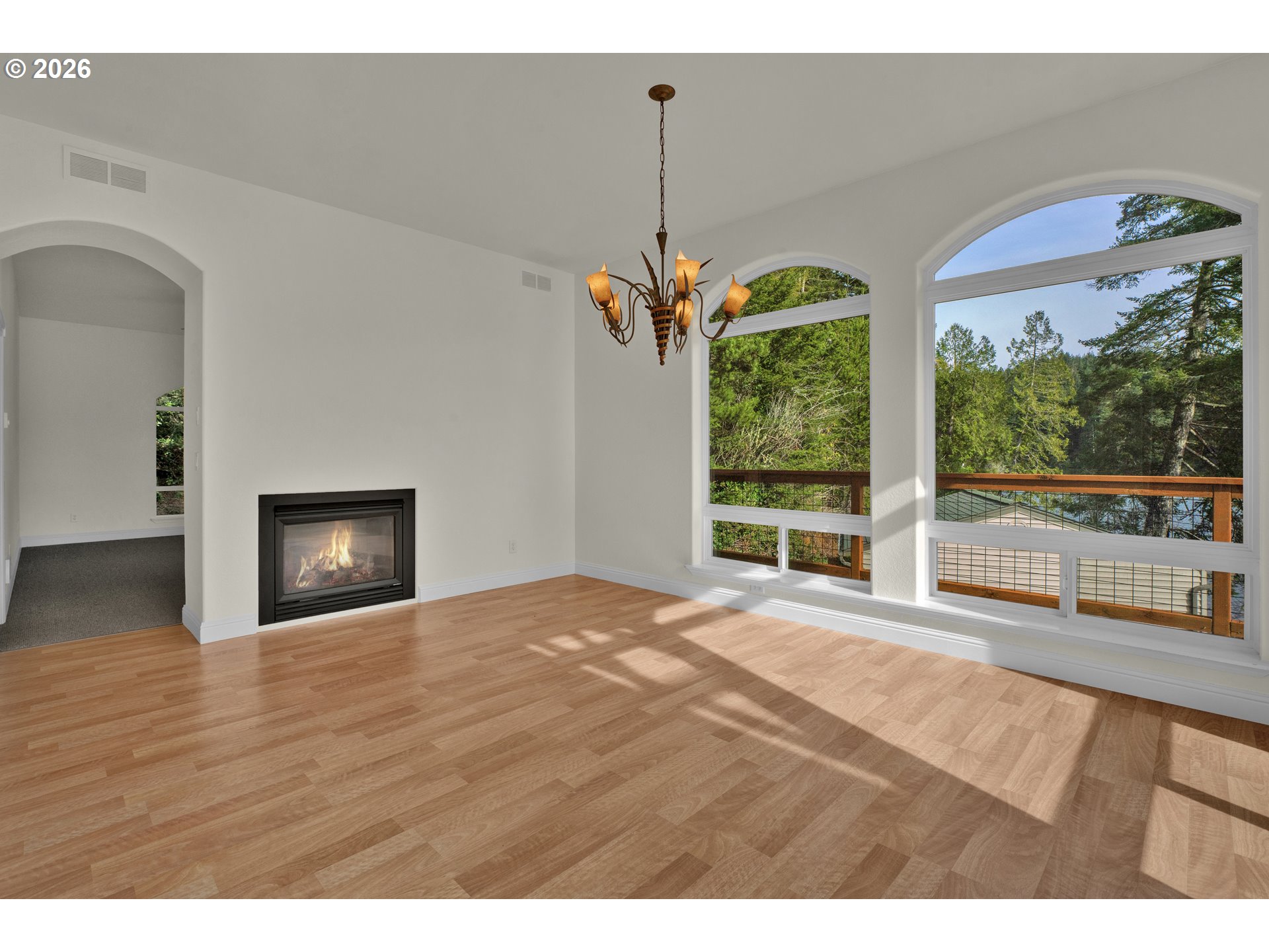 5816 Martin Road Florence, OR 97439 - Photo 22 of 47 a view of an empty room with a fireplace and a window
