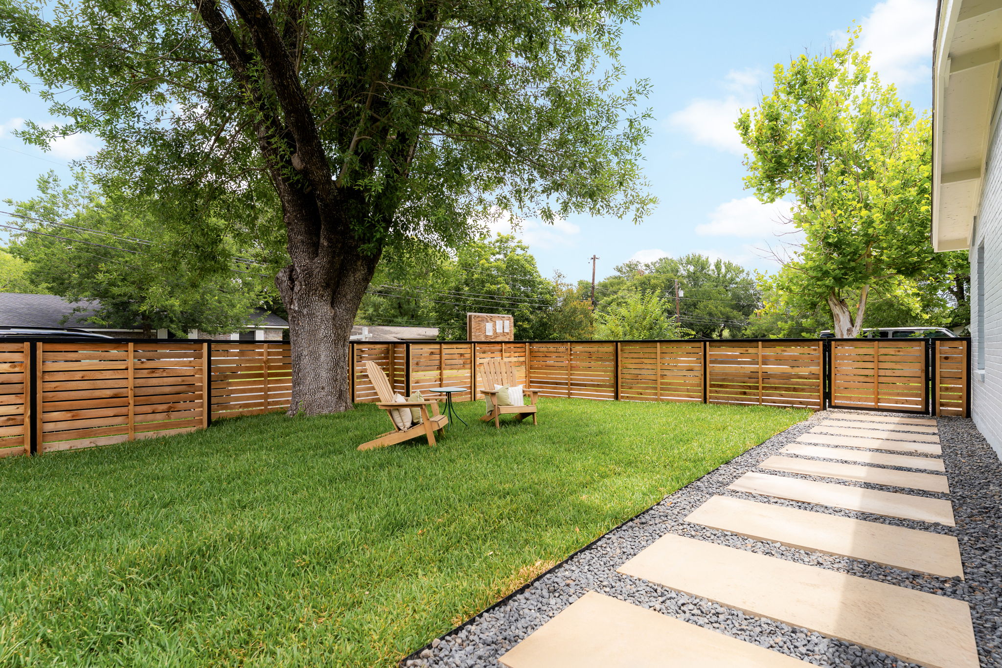4902 Blueberry Trail, Unit 1 Austin, TX 78723 - Photo 30 of 30 a view of a backyard with wooden fence and a bench