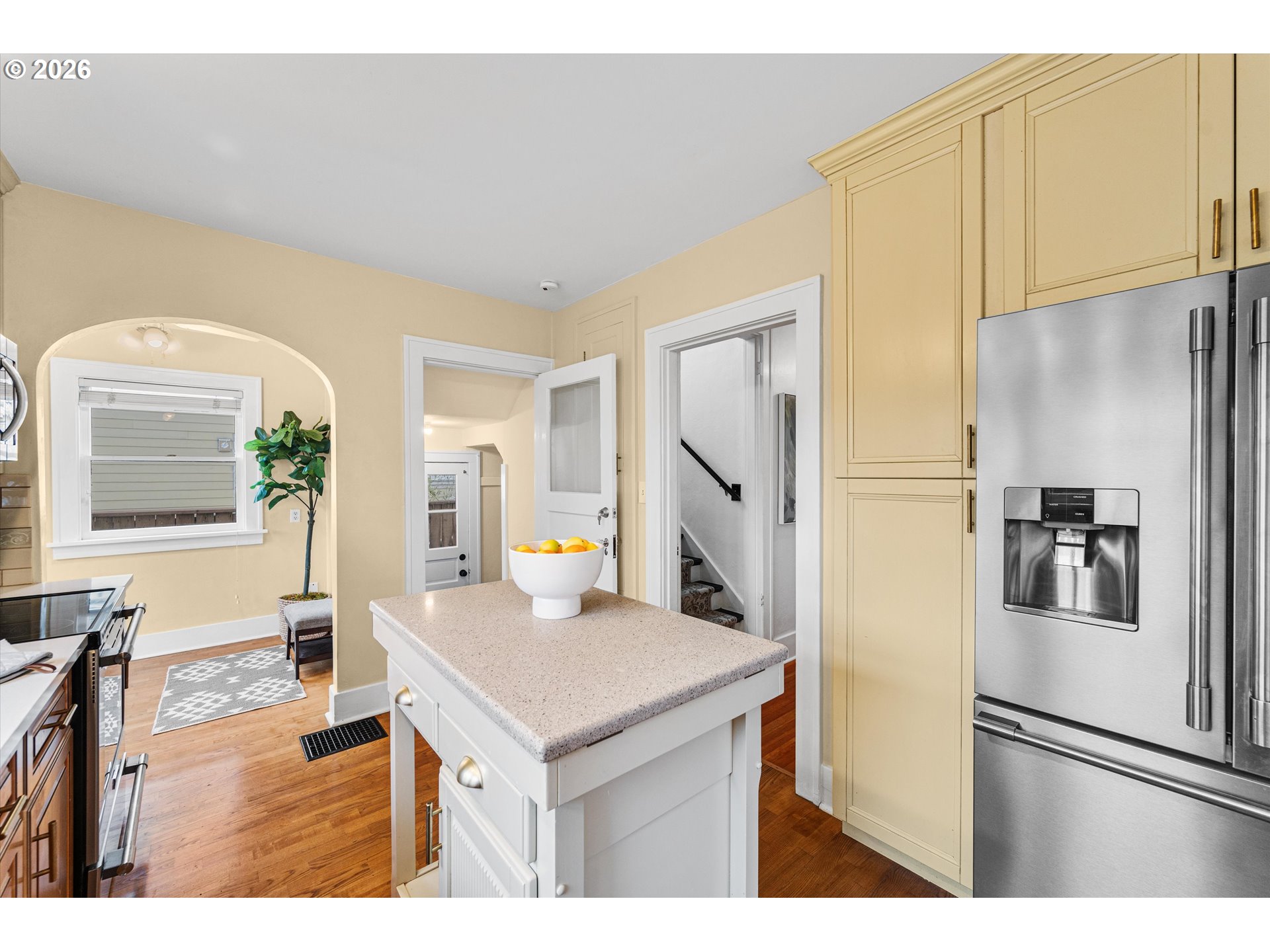1706 Southeast Knapp Street Portland, OR 97202 - Photo 13 of 43 a kitchen with stainless steel appliances a refrigerator a sink a stove a dining table and chairs