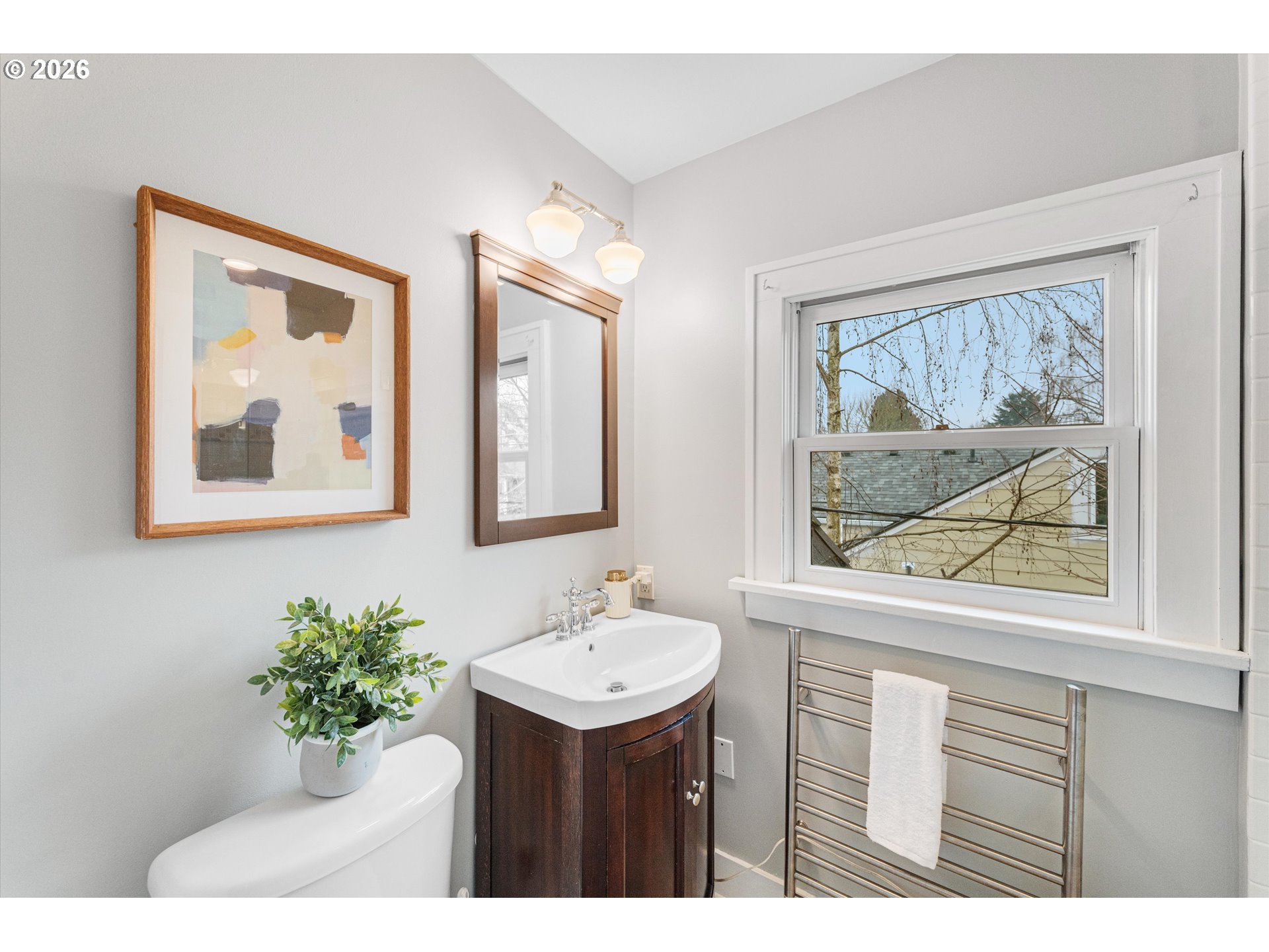 1706 Southeast Knapp Street Portland, OR 97202 - Photo 22 of 43 a bathroom with a sink mirror and a painting on the wall