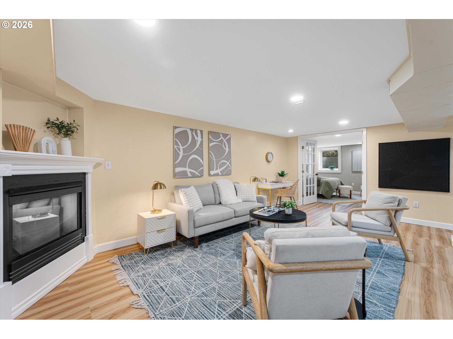 1706 Southeast Knapp Street Portland, OR 97202 - Photo 26 of 43 a living room with furniture a fireplace and a flat screen tv