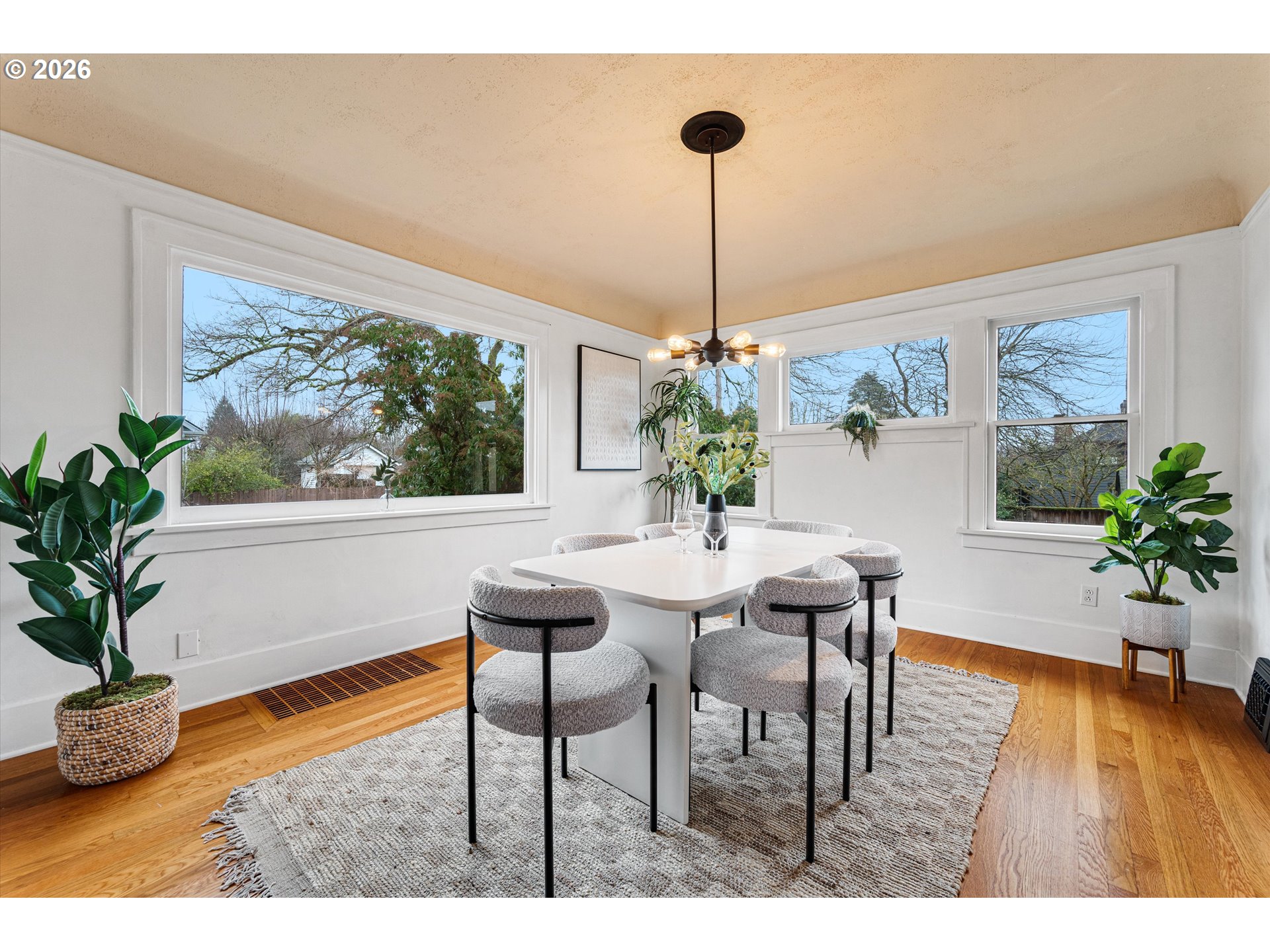 1706 Southeast Knapp Street Portland, OR 97202 - Photo 8 of 43 a dining room with furniture a potted plant and a chandelier