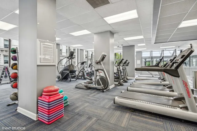 a room with gym equipment and view of living room